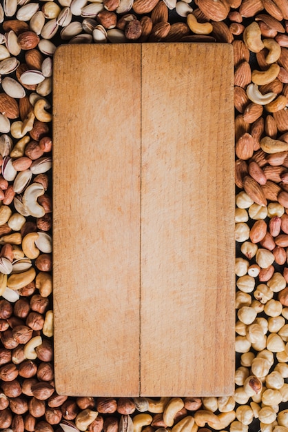 Wooden board on assorted nuts