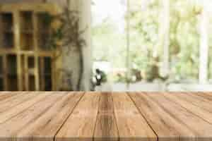 Free photo wooden board empty table in front of blurred background. perspective brown wood over blur in coffee shop - can be used for display or montage your products.mock up for display of product.