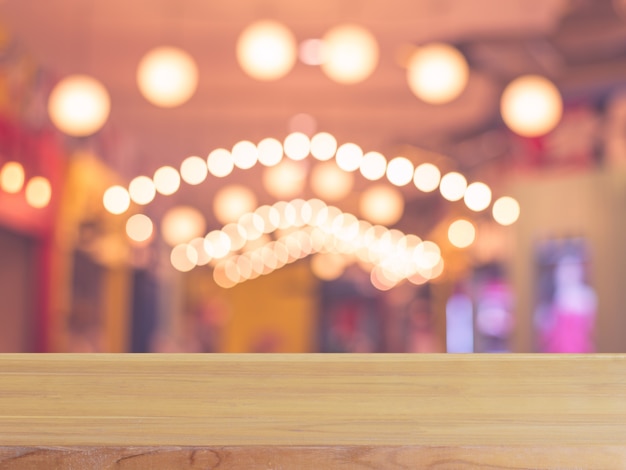 Wooden board empty table in front of blurred background. Perspective brown wood over blur in coffee shop