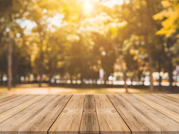 Wooden board empty table in front of blurred background. Perspective brown wood table over blur trees in forest background - can be used mock up for display or montage your products. autumn season.