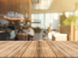 Wooden board empty table top on of blurred background.