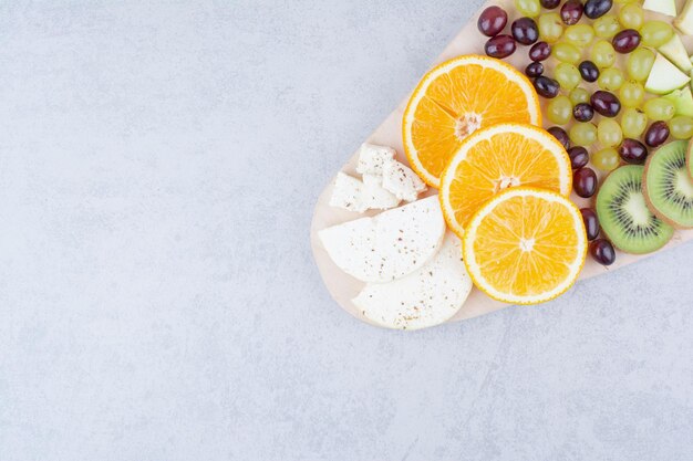 A wooden board of fresh fruits on white background. High quality photo