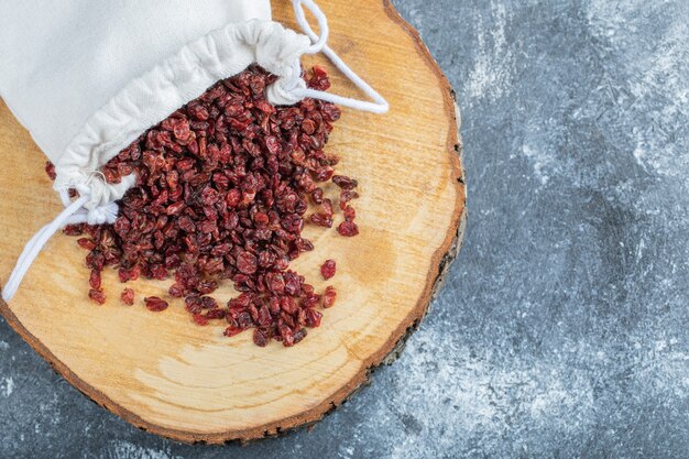 A wooden board full of dried cranberries. 