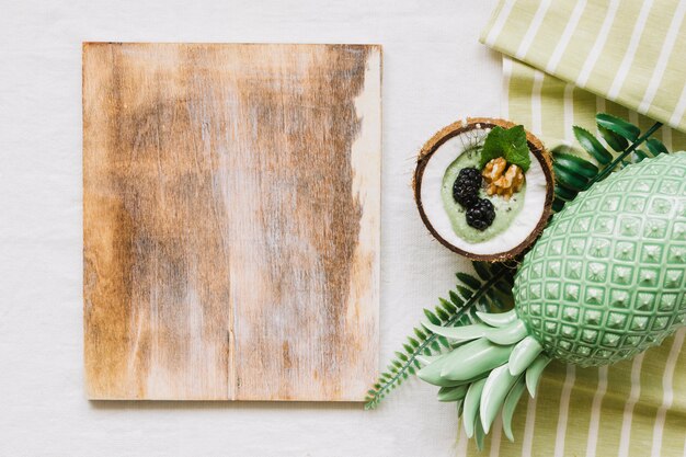 Wooden board and summer smoothie in coconut