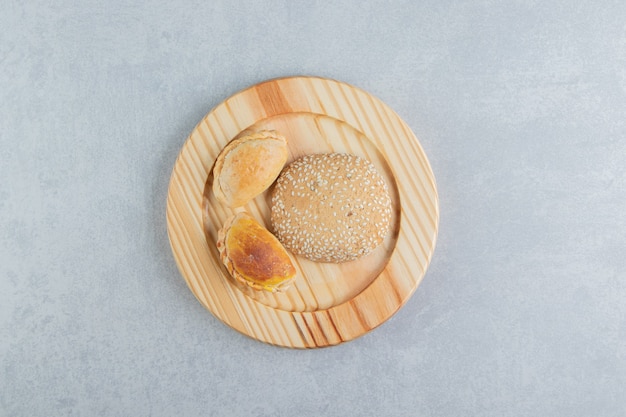 A wooden board of sweet delicious pastries .  