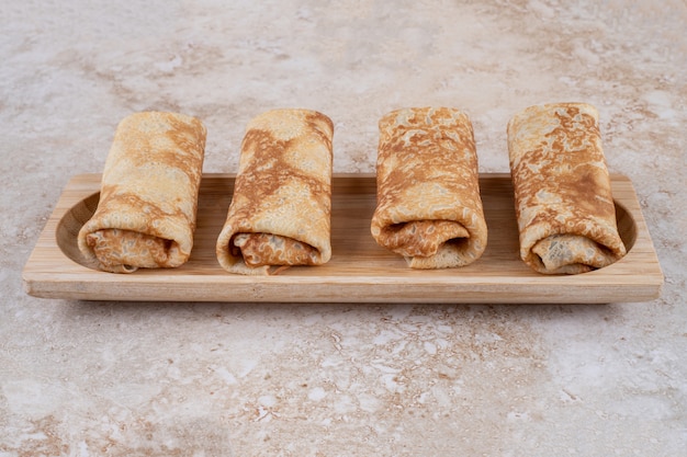 A wooden board of tasty homemade crepes 