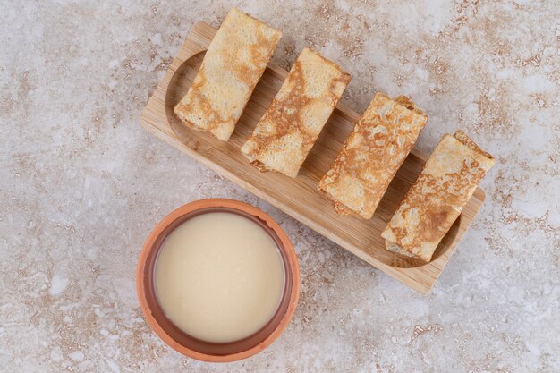 A wooden board of tasty homemade crepes 