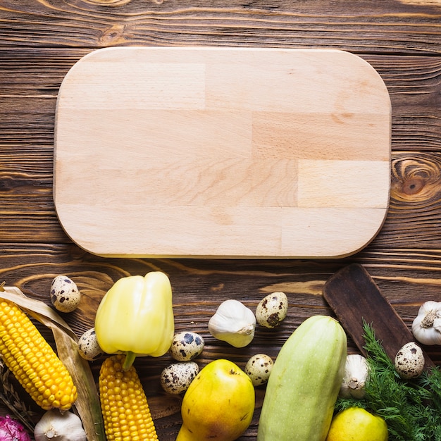 Wooden board above vegetables