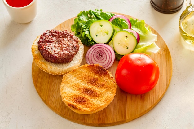 Wooden board with hamburger on table