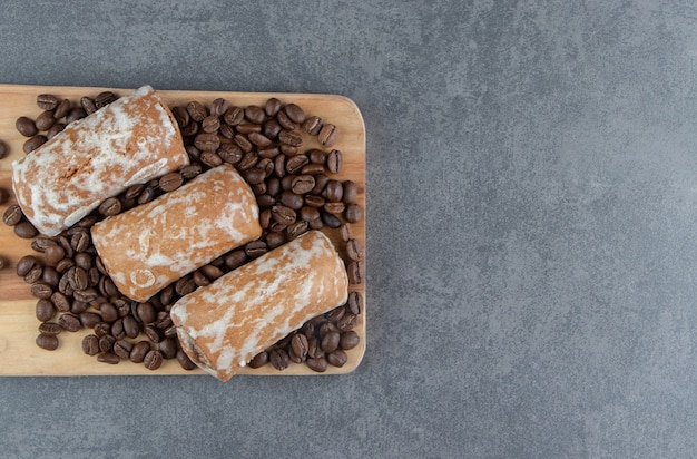 A wooden board with sweet gingerbread and coffee beans 