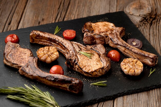 Wooden board with tasty cooked meat