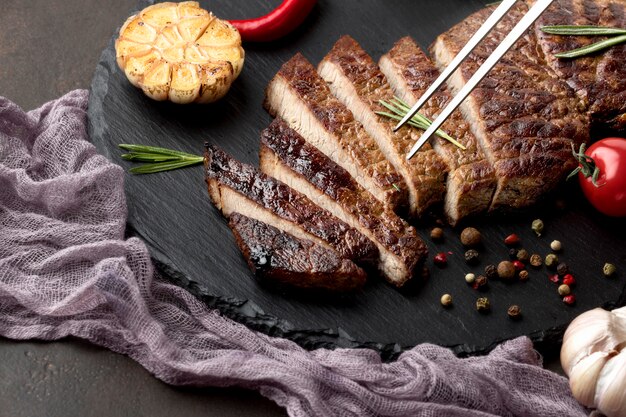 Wooden board with tasty cooked meat