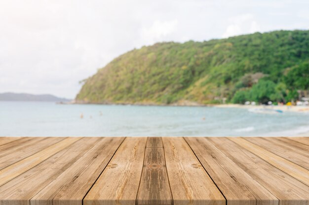 Wooden boards with blurred beach background