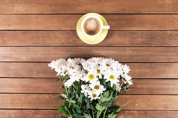 Wooden boards with coffee cup and flowers