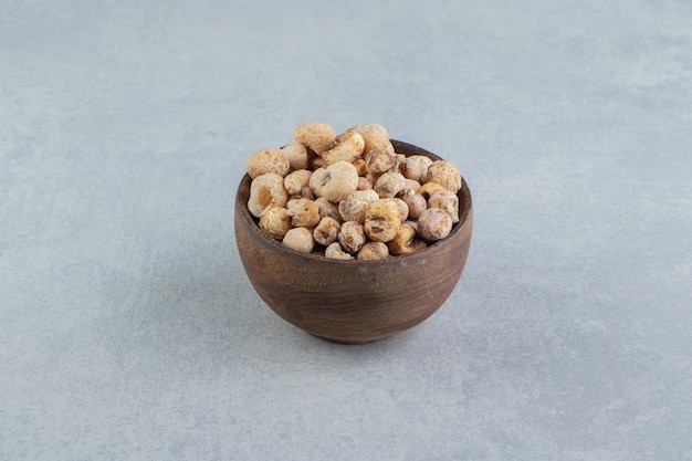 A wooden bowl full of delicious dried fruit .