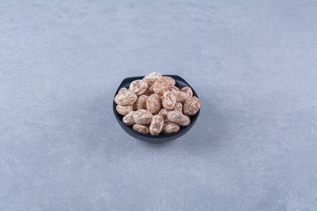 A wooden bowl full of healthy cereals on gray surface