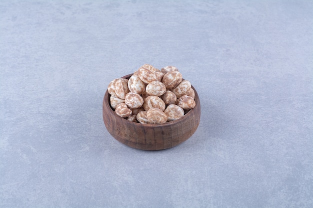 A wooden bowl full of healthy cereals on gray surface