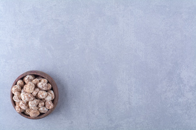 A wooden bowl full of healthy cereals on gray table. 