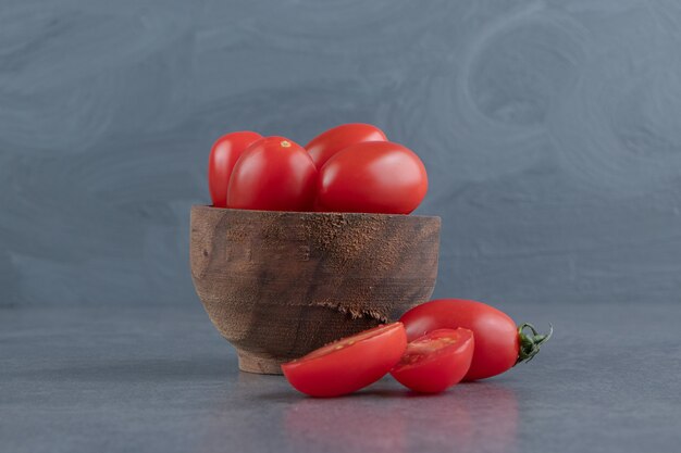 A wooden bowl of red cherry tomatoes 