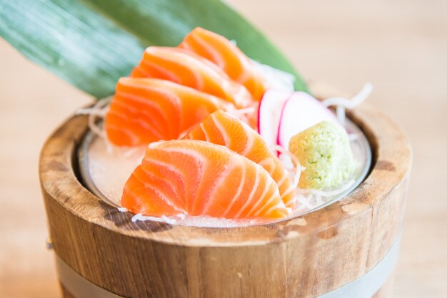 Wooden bowl with fresh salmon fillets