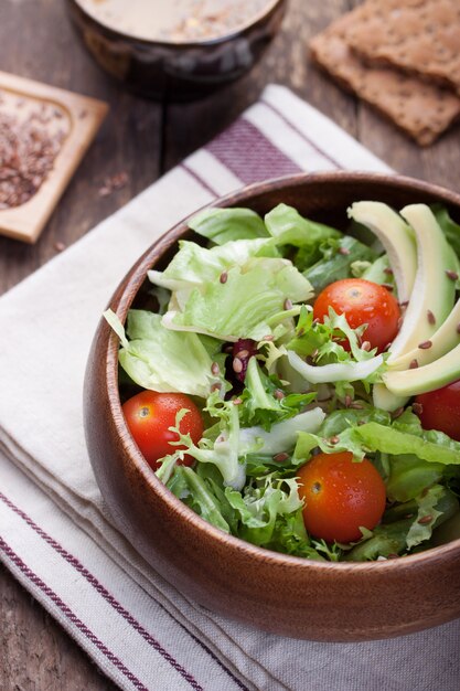 Wooden bowl with salad seen from above