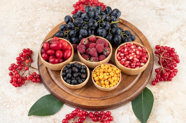 A wooden bowls full of delicious berries .