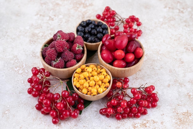 A wooden bowls full of delicious berries .