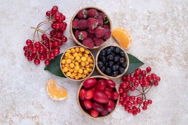 Free photo a wooden bowls full of delicious berries .