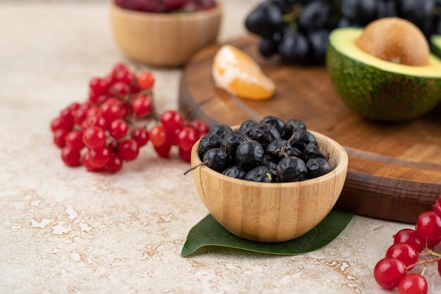 A wooden bowls full of delicious berries .