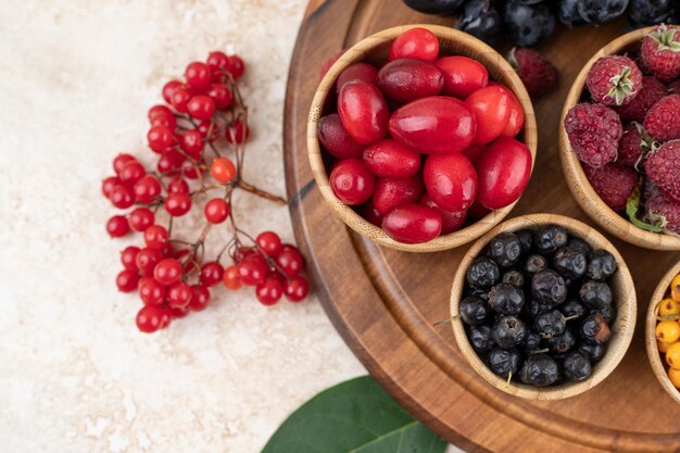 A wooden bowls full of delicious berries .