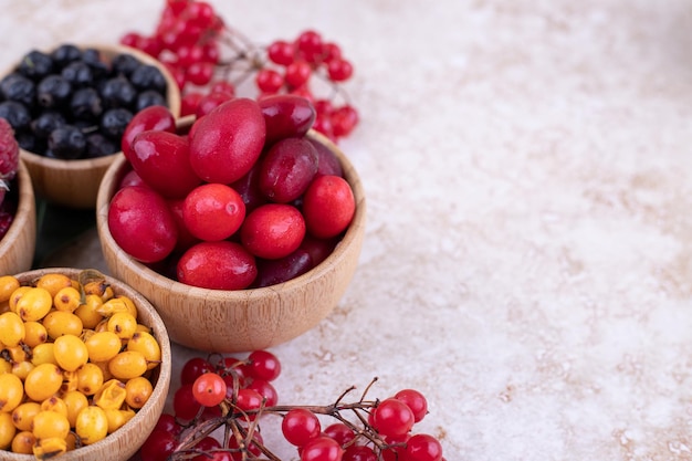 A wooden bowls full of delicious berries .