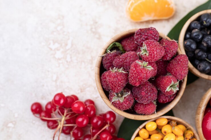 Free Photo a wooden bowls full of delicious berries .