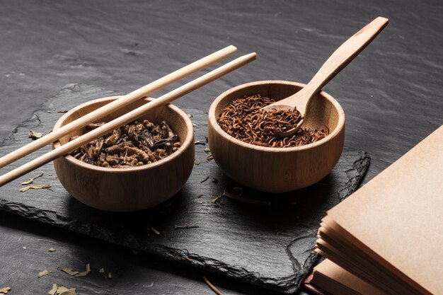 Wooden bowls with insects on slate board