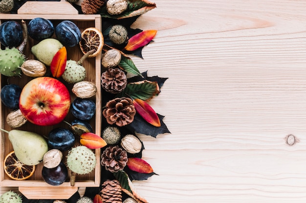 Wooden box with assortment of autumn fruits