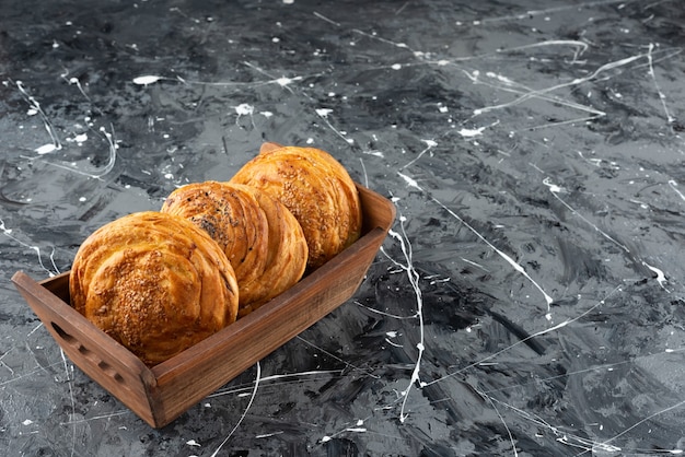 A wooden box with Azerbaijan national pastry on a marble background. 