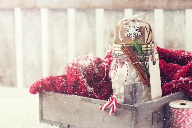 Free photo wooden box with a glass jar with a gift over