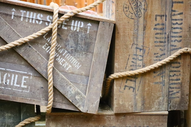 Wooden box with text written on them and ropes around them