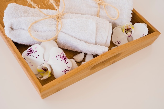 Free photo wooden box with towels and flowers