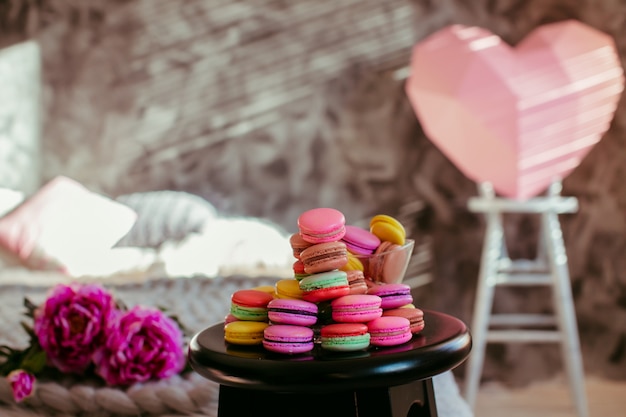 Wooden chair with colorful macaroons stands in the room