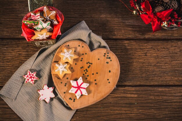 Wooden chopping board with cookies viewed from above