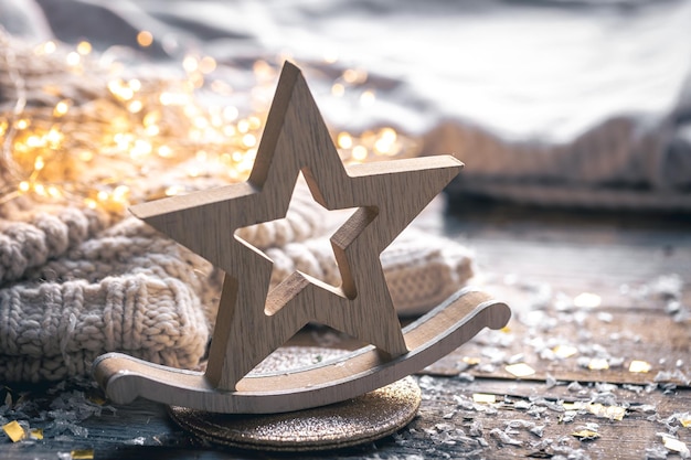 Free photo wooden christmas star on a blurred background with lights
