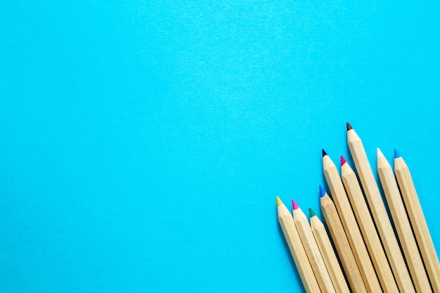 Free photo wooden colored pencils on a blue background top view