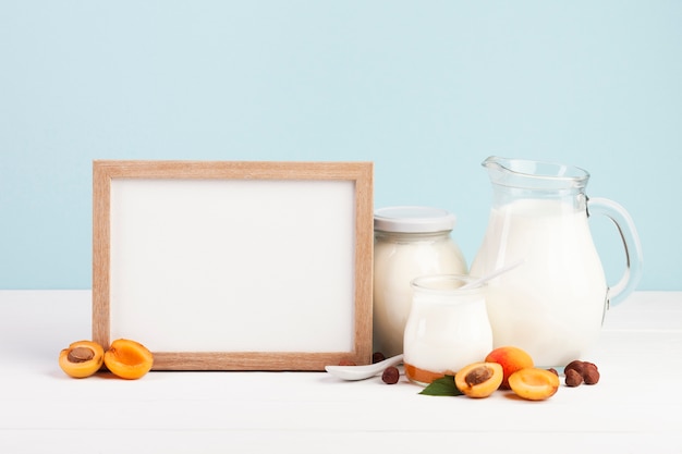 Wooden copy space frame and dairy products