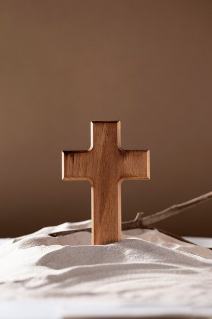 Wooden cross, branches and sand arrangement