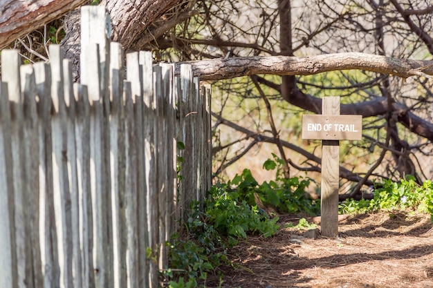 Free photo wooden cross on nature with a wooden fence next to it