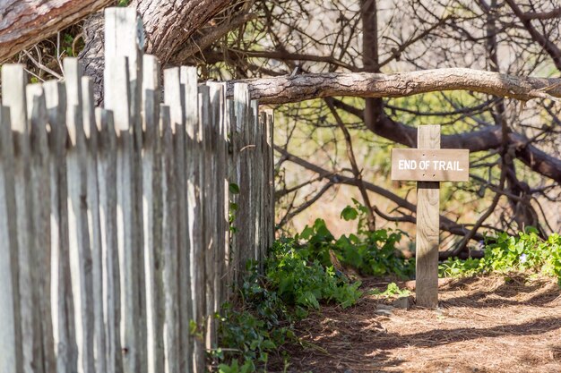 Wooden cross on nature with a wooden fence next to it