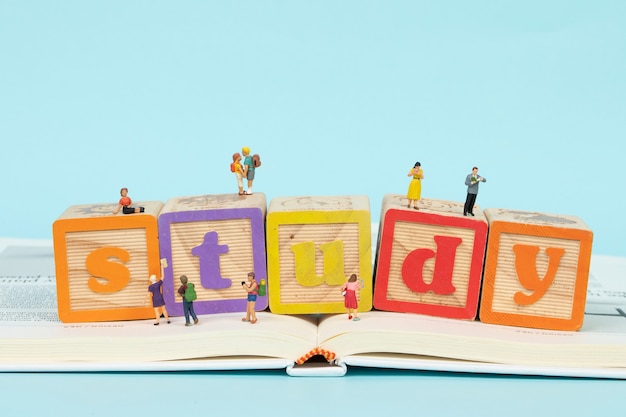 wooden cubes with colored letters on book