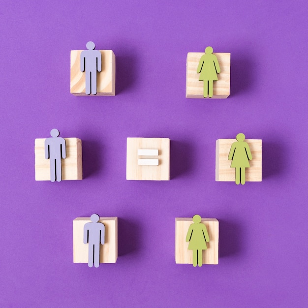 Free photo wooden cubes with green women and blue men figurines equality concept