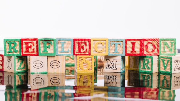 Free photo wooden cubes with reflection title