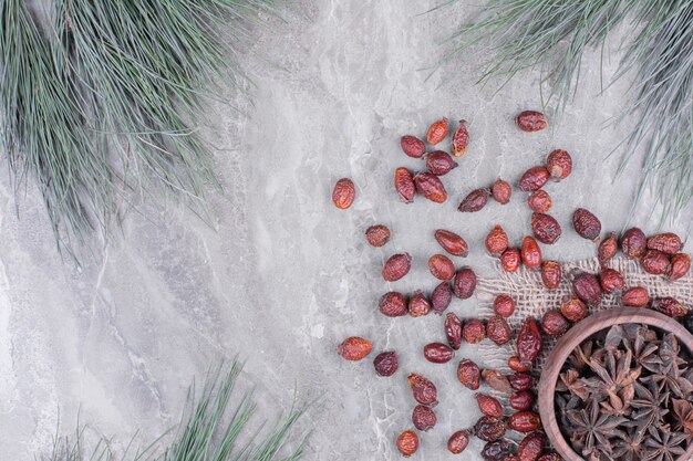 A wooden cup full of anise flowers on the marble